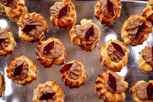 Profitrols with whipped cream on a dark background. Traditional French dessert