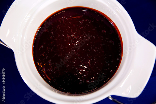 Sweet red berry jam or confiture in a bowl isolated