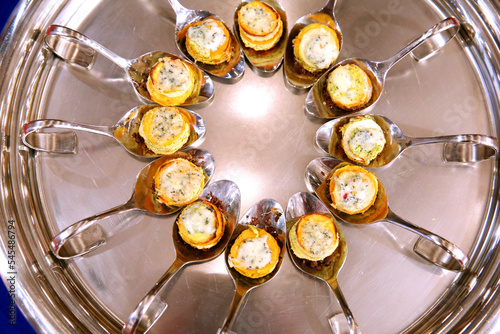 A plate with canapes on spoons. Catering banquet. Table with snacks and canapes at a banquet