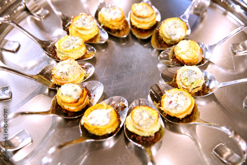 A plate with canapes on spoons. Catering banquet. Table with snacks and canapes at a banquet