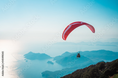 Paraglider flying on Oludeniz beach in Fethiye, Mugla. Travel destination. Summer and holiday concept.