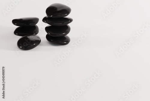 Black decorative stones on a light background. The concept of furnishing a room  apartment  house. Black pebbles. 3D render  3D illustration.