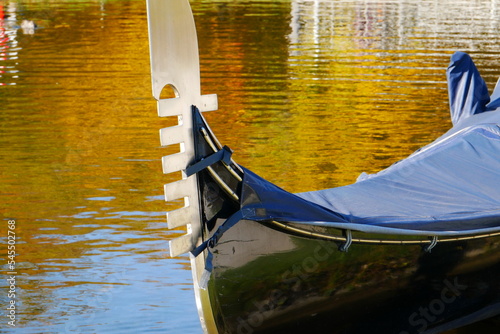 close-up of a venetian gondola with rain cover and metal tail as bow fitting