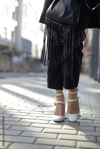 Front view close up of woman legs with high heels outside