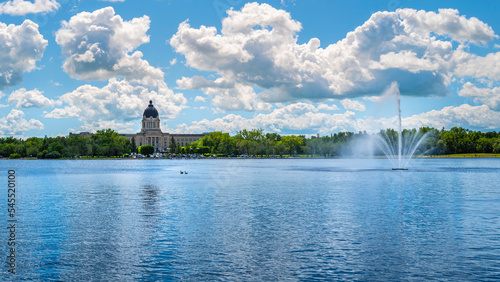 Wascana Park panoramic landscape with lake, fountain and Saskatchewan Legislative Building in Regina Saskatchewan Canada photo