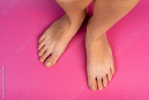 legs of a teenage girl on a pink background