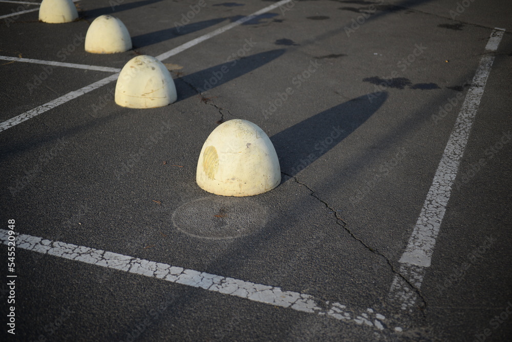 concrete traffic limiters concrete markers painted white, parking space
