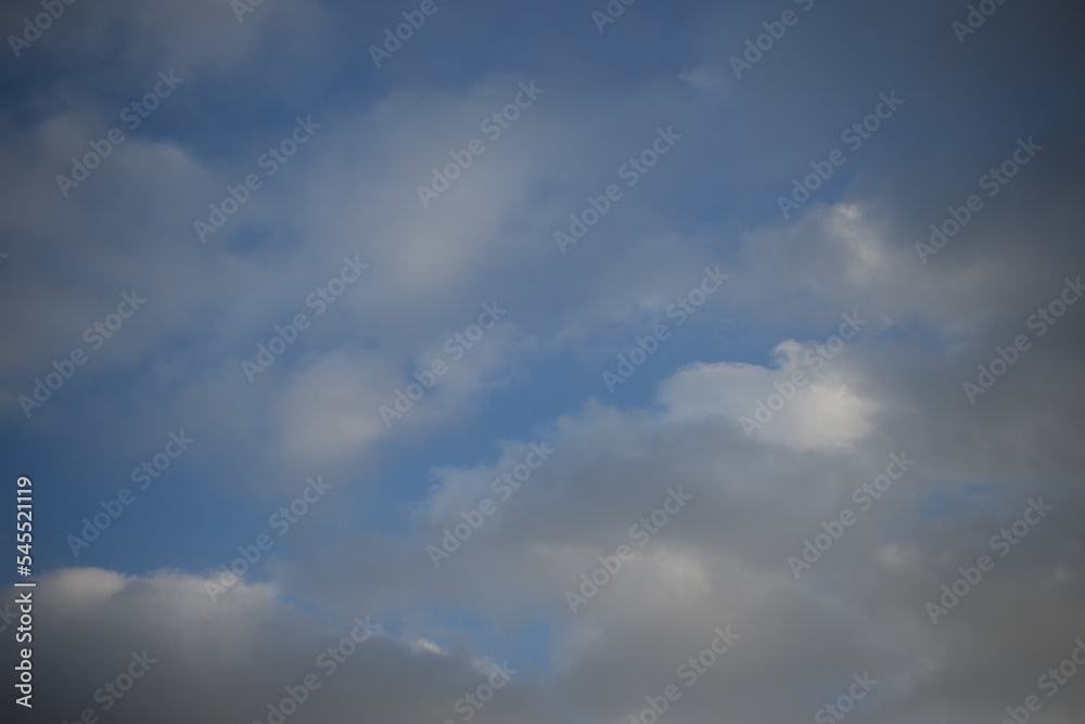 background of daytime cloudy sky white clouds rainy weather blue sky sun rays texture of sky and cirrus clouds in a city in Ukraine, atmosphere, peaceful sky stratosphere  before the rain 
