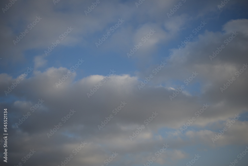 background of daytime cloudy sky white clouds rainy weather blue sky sun rays texture of sky and cirrus clouds in a city in Ukraine, atmosphere, peaceful sky stratosphere  before the rain 