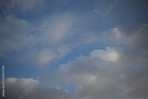 Fototapeta Naklejka Na Ścianę i Meble -  background of daytime cloudy sky white clouds rainy weather blue sky sun rays texture of sky and cirrus clouds in a city in Ukraine, atmosphere, peaceful sky stratosphere  before the rain 