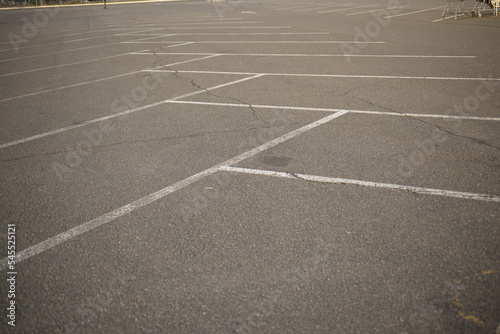 white lines abstract on asphalt  road markings white stripes on the asphalt road  parking spaces separated by white lines  symmetrical abstract lines on gray asphalt