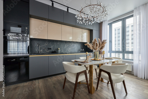 Modern interior of studio apartment in gray and  white colors and tones. White furniture and door. Expensive and luxury design