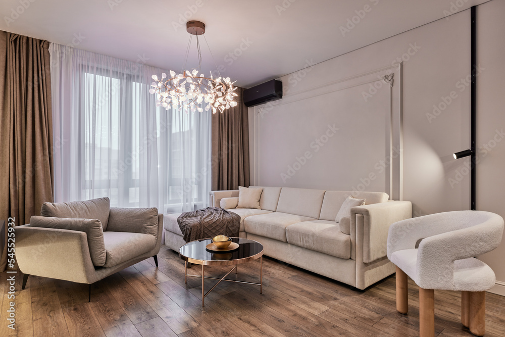 Fototapeta premium Modern interior of studio apartment in gray and white colors and tones. White furniture and door. Expensive and luxury design