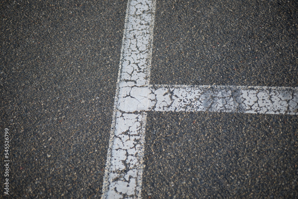 white lines abstract on asphalt, road markings white stripes on the asphalt road, parking spaces separated by white lines, symmetrical abstract lines on gray asphalt	
