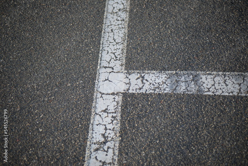 white lines abstract on asphalt, road markings white stripes on the asphalt road, parking spaces separated by white lines, symmetrical abstract lines on gray asphalt	

