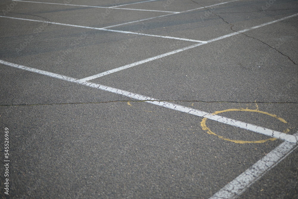 white lines abstract on asphalt, road markings white stripes on the asphalt road, parking spaces separated by white lines, symmetrical abstract lines on gray asphalt