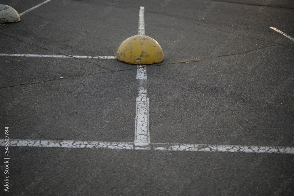 concrete traffic limiters concrete markers painted white, parking space