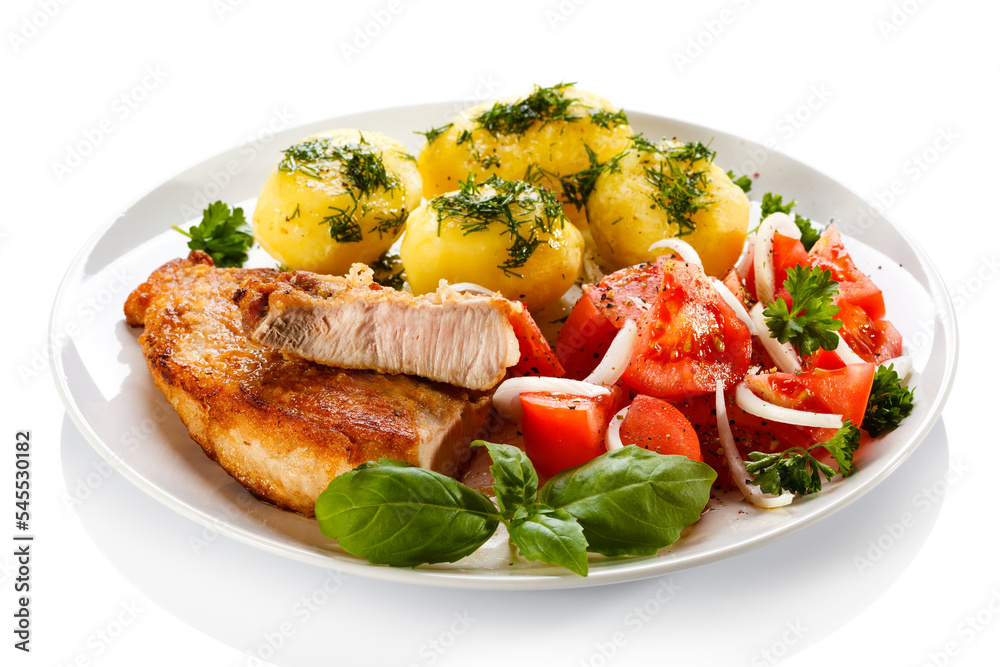 Grilled steaks, boiled potatoes and vegetable salad Grilled steaks, boiled potatoes and vegetable salad