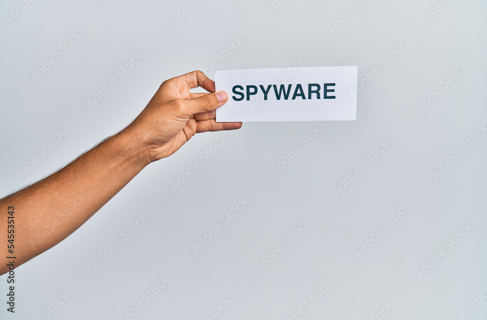 Hand of caucasian man holding paper with spyware word over isolated white background Hand of caucasian man holding paper with spyware word over isolated white background