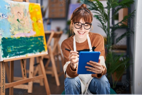 Young woman artist using touchpad at art studio photo