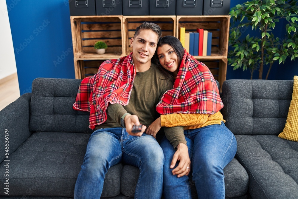 Man and woman couple hugging each other watching tv at home Stock Photo ...