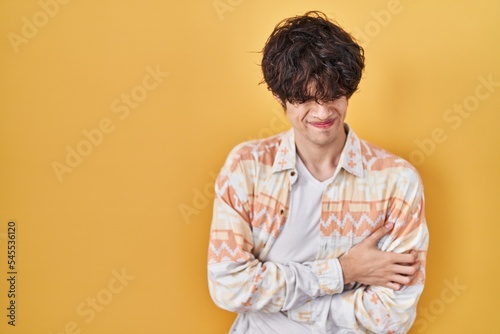 Young man wearing casual summer shirt with hand on stomach because nausea, painful disease feeling unwell. ache concept. © Krakenimages.com