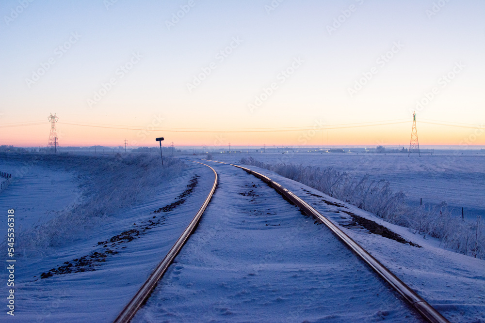 Sunrise over railway on cold winter day in Alberta