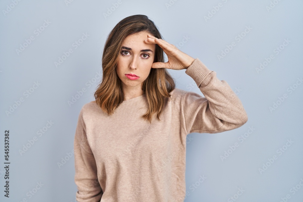 Young woman standing over isolated background worried and stressed about a problem with hand on forehead, nervous and anxious for crisis Young woman standing over isolated background worried and stressed about a problem with hand on forehead, nervous and anxious for crisis