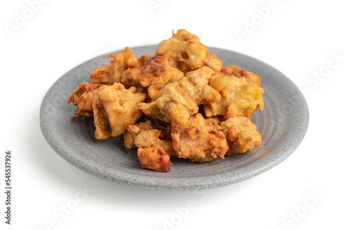 banana fritter or fried banana on a plate isolated on white background
