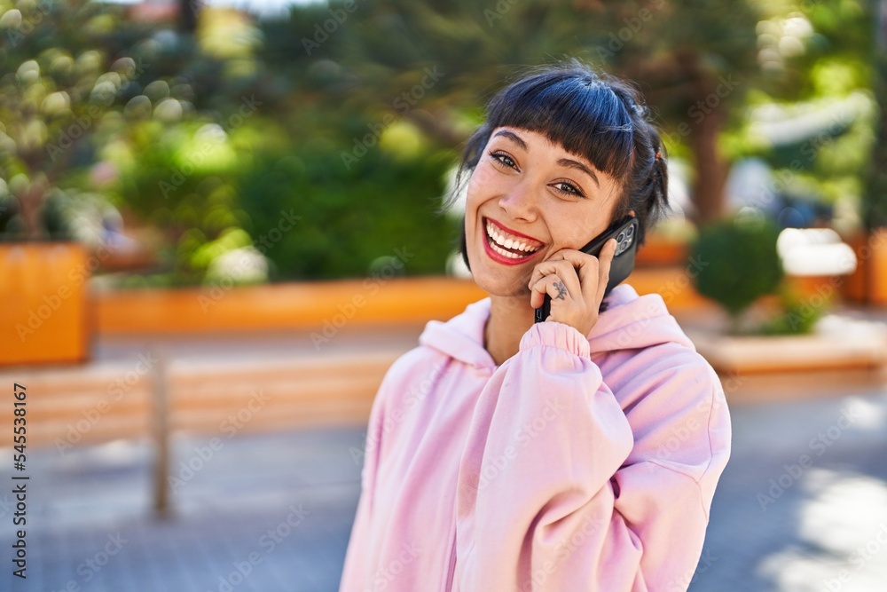 Young woman smiling confident talking on the smartphone at park Young woman smiling confident talking on the smartphone at park