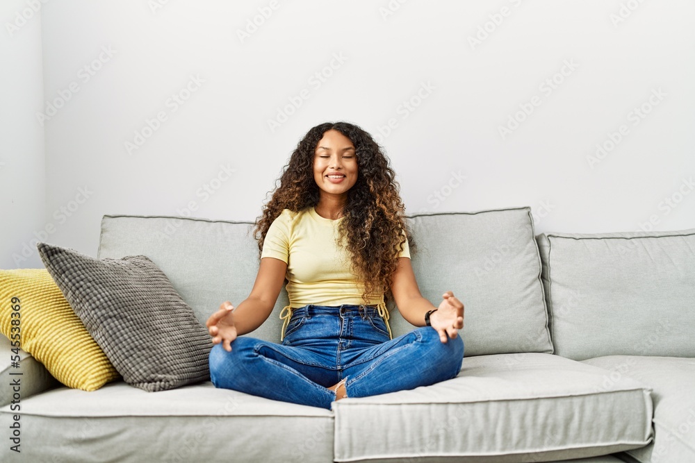 Young latin woman smiling confident doing yoga exercise at home Young latin woman smiling confident doing yoga exercise at home