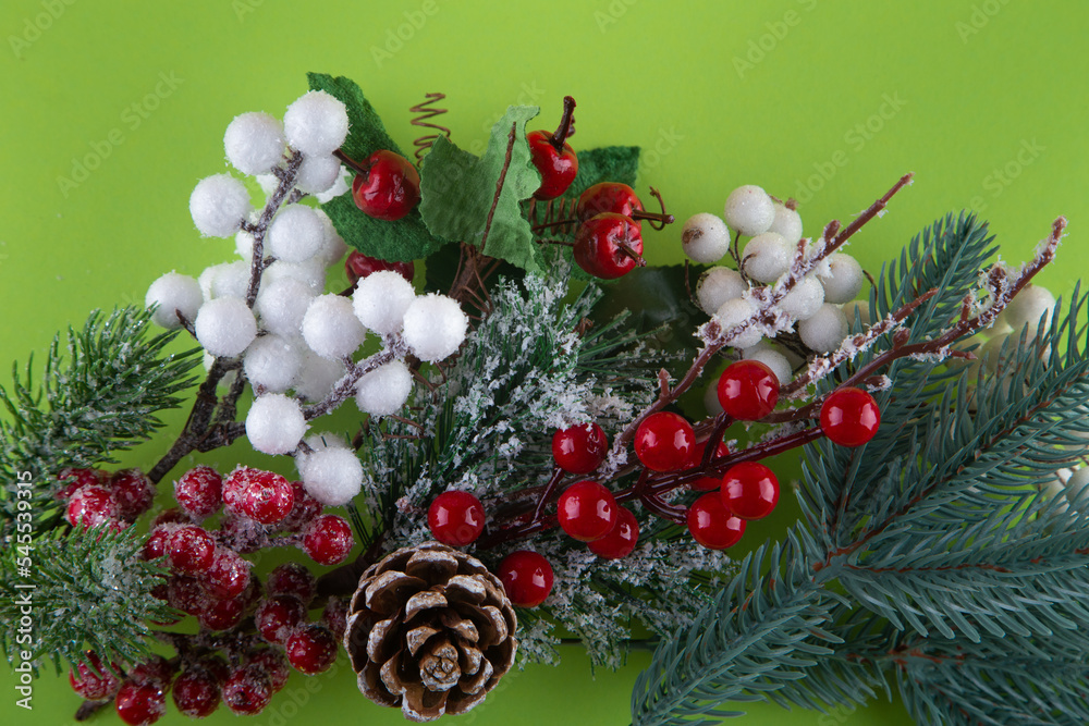 Christmas decoration. Top view on green pine tree branch, cone, red, white winter berries. Happy new year concept