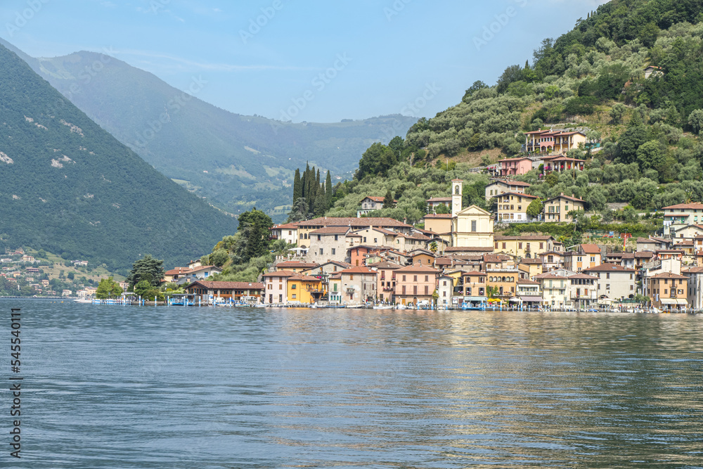 Landscape of the lakeside of Peshiera Maraglio in Monte Isola with beautiful colored houses reflecting in the water