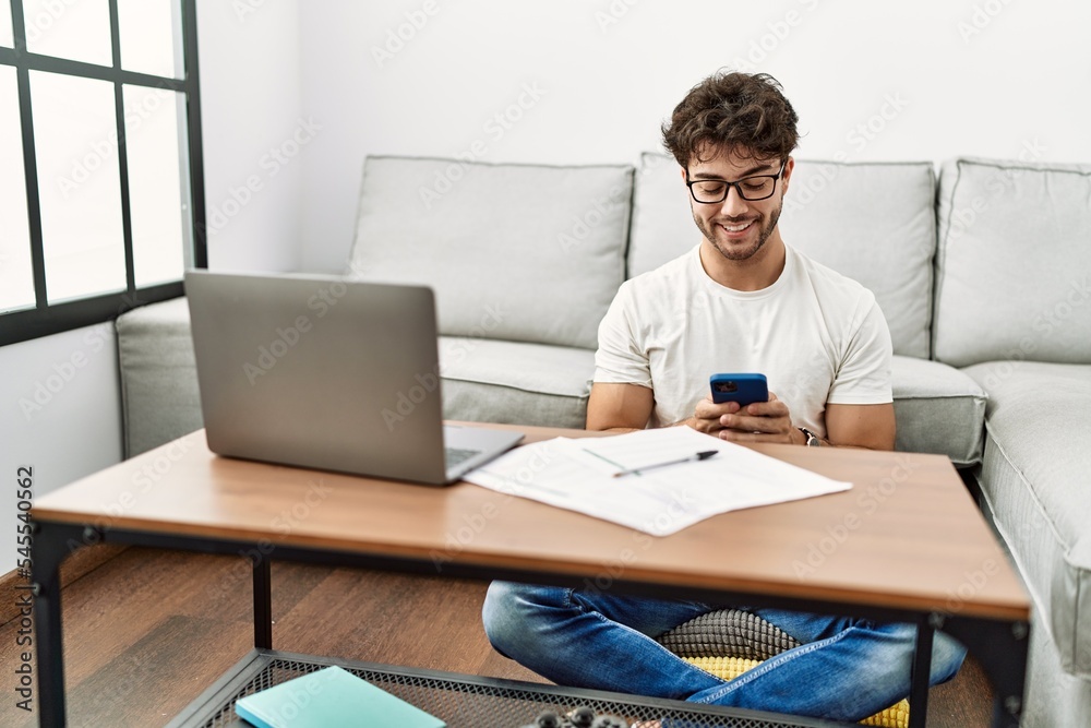Young hispanic man smiling confident working at home