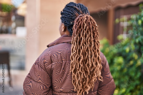 African american woman standing on back view at street
