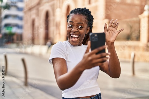 African american woman smiling confident having video call at street