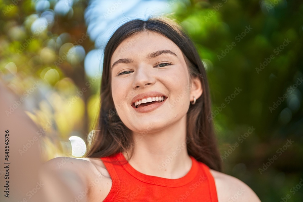 Young caucasian woman smiling confident making selfie by camera at park