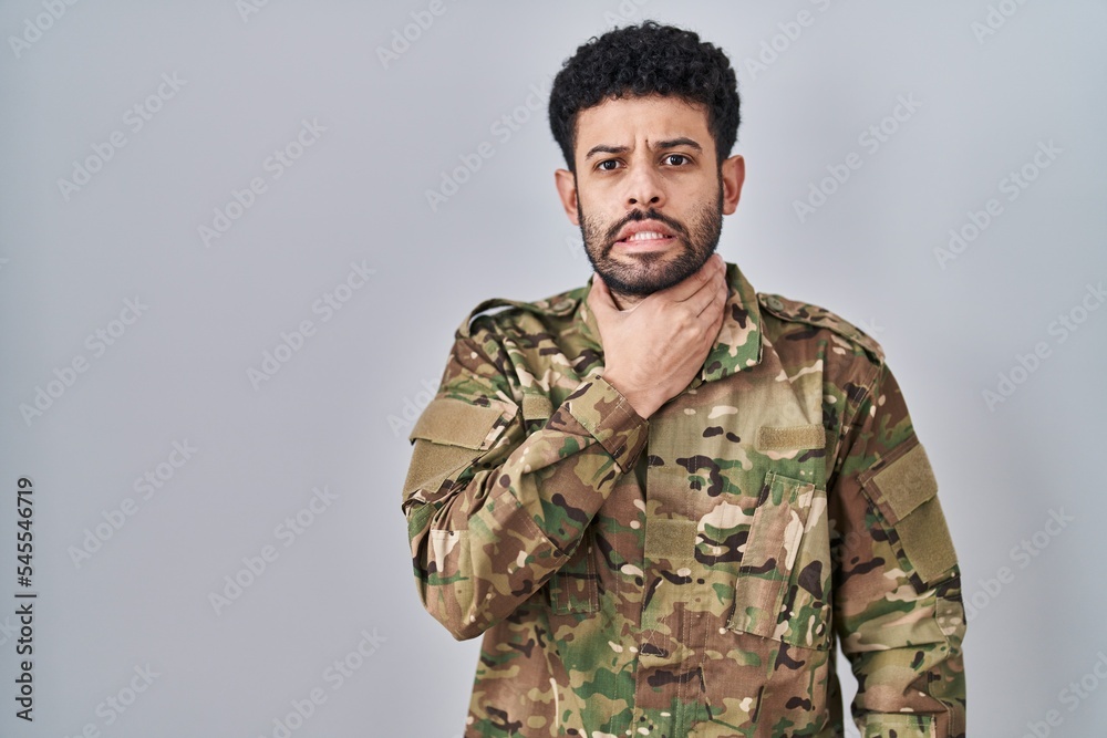 Arab man wearing camouflage army uniform shouting suffocate because painful strangle. health problem. asphyxiate and suicide concept.