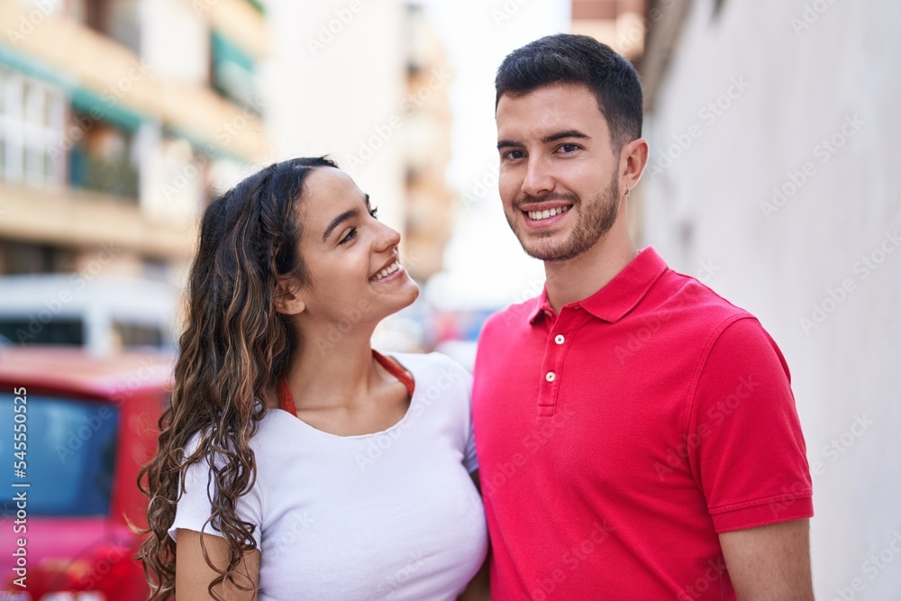 Young hispanic couple smiling confident hugging each other at street Young hispanic couple smiling confident hugging each other at street