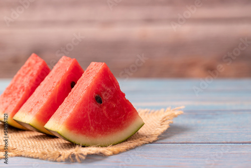 3 pieces of watermelon slices on the wooden table