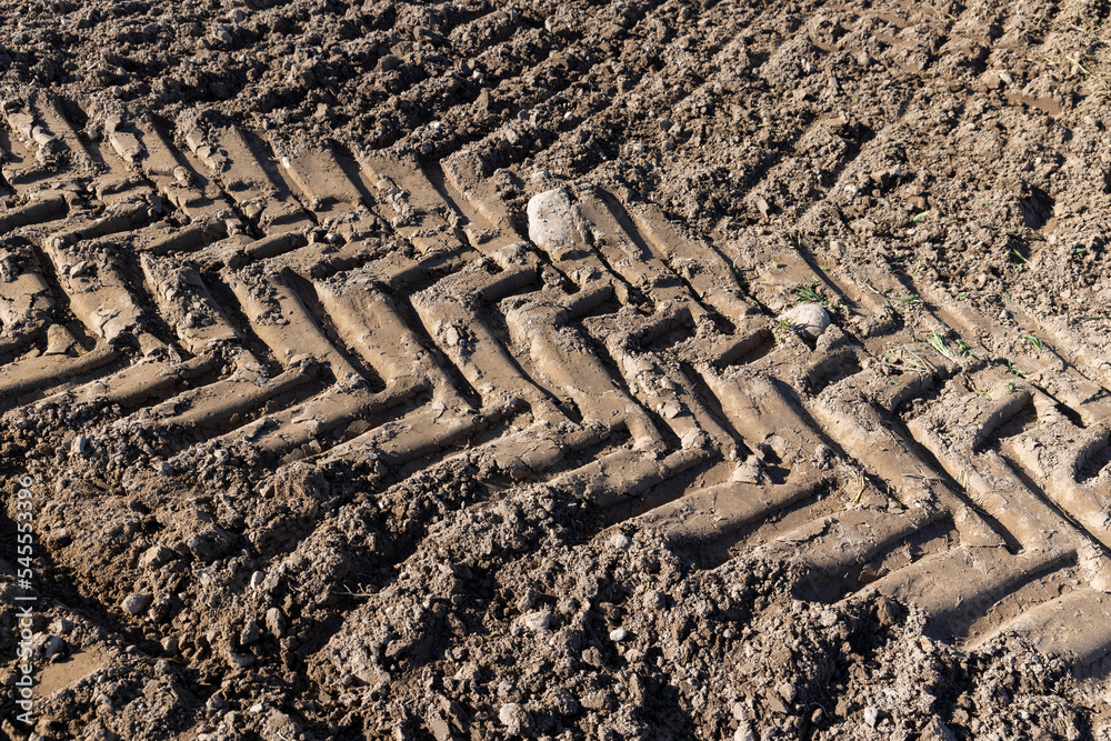 Traces of a tractor or other large machinery on the soil in the field Traces of a tractor or other large machinery on the soil in the field