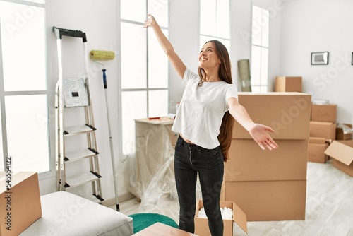 Young hispanic woman smiling confident standing at new home