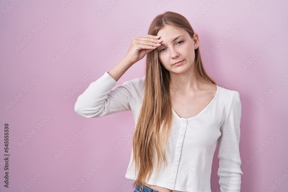 Young caucasian woman standing over pink background worried and stressed about a problem with hand on forehead, nervous and anxious for crisis Young caucasian woman standing over pink background worried and stressed about a problem with hand on forehead, nervous and anxious for crisis