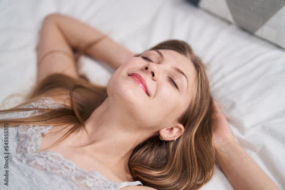 Young caucasian woman smiling confident relaxed on bed at bedroom Young caucasian woman smiling confident relaxed on bed at bedroom