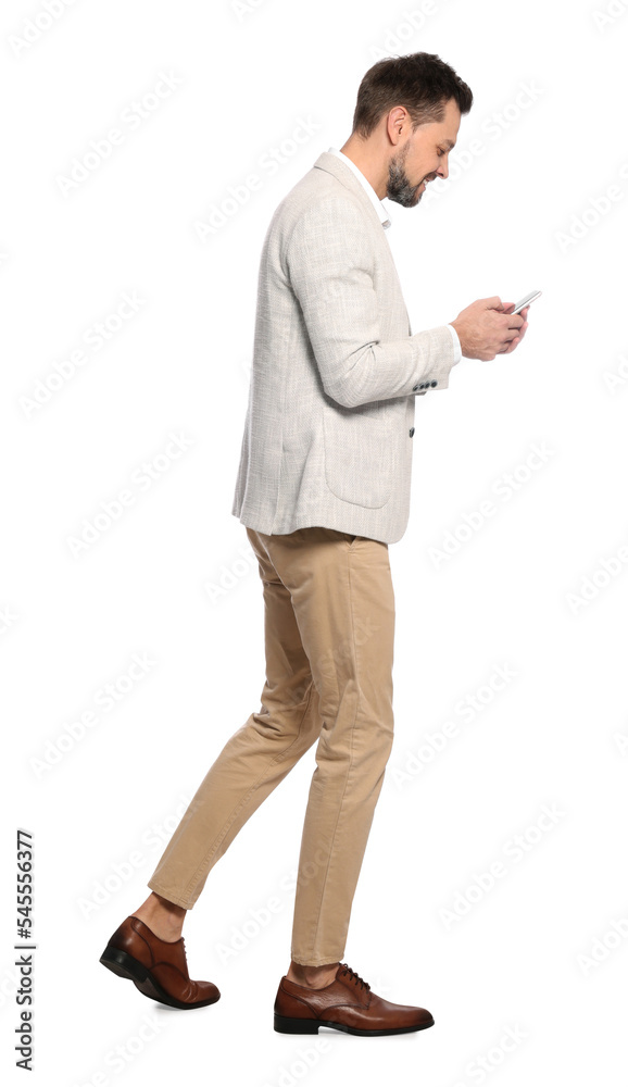 Man using smartphone while walking on white background Man using smartphone while walking on white background