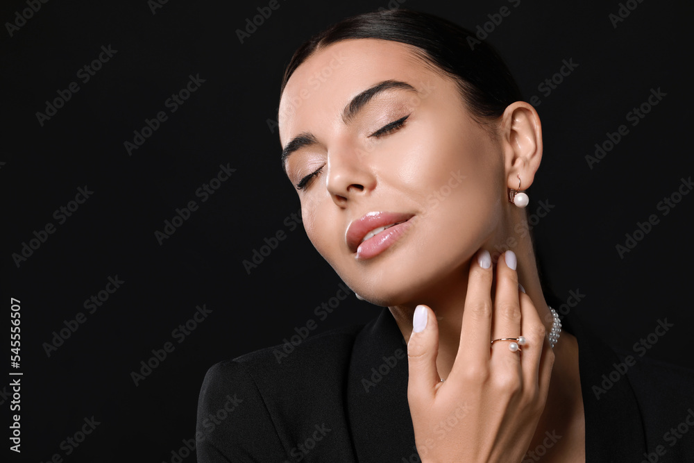 Young woman with elegant pearl jewelry on black background, space for text Young woman with elegant pearl jewelry on black background, space for text