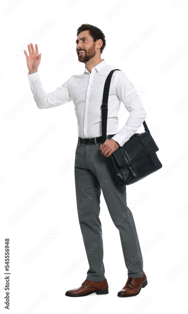 Handsome man with black bag waving to say hello while walking on white background Handsome man with black bag waving to say hello while walking on white background