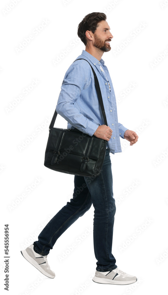 Handsome man with bag in stylish outfit walking on white background Handsome man with bag in stylish outfit walking on white background