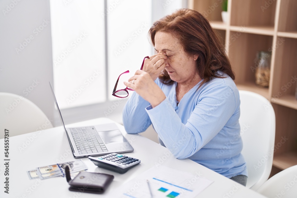 Senior woman stressed using laptop at home Senior woman stressed using laptop at home