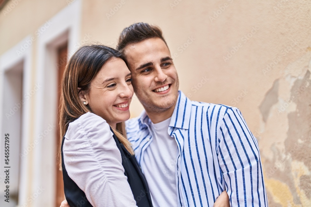 Man and woman couple smiling confident hugging each other at street Man and woman couple smiling confident hugging each other at street